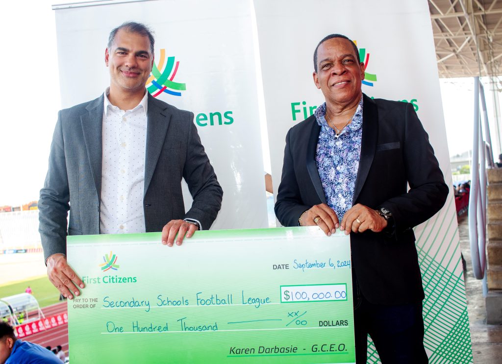 (l-r) Sacha Syne, General Manager – Corporate and Investment Banking, First Citizens presents to Merere Gonzales, President – Secondary Schools Football League