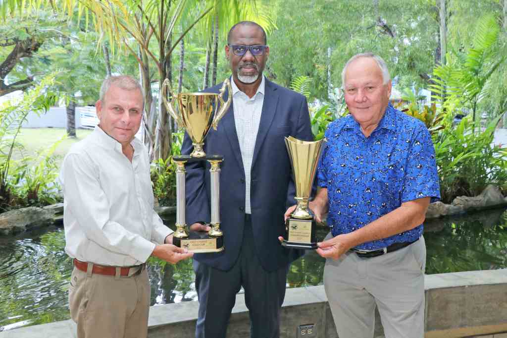 (l-r) Roger Hadeed – Member, Arima Race Club, Carver Trim - General Manager – Trustee Services, First Citizens and John O’Brien – Management Committee Member, Arima Race Club show the Boxing Day trophies for the First Citizens Gold Cup and First Citizens Juvenile Championship